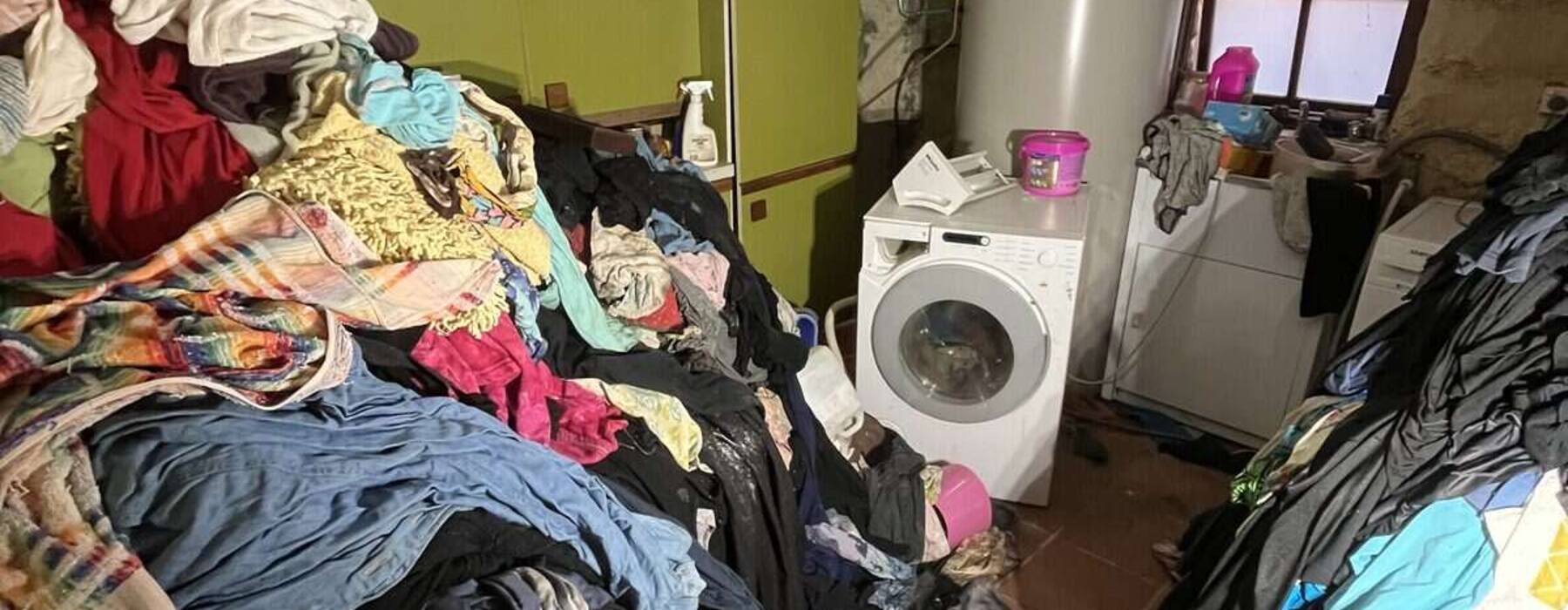 Room piled with belongings, before