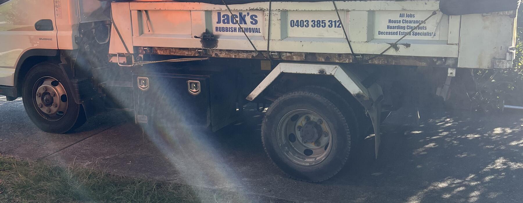 Orange tipper on a job, sun flare