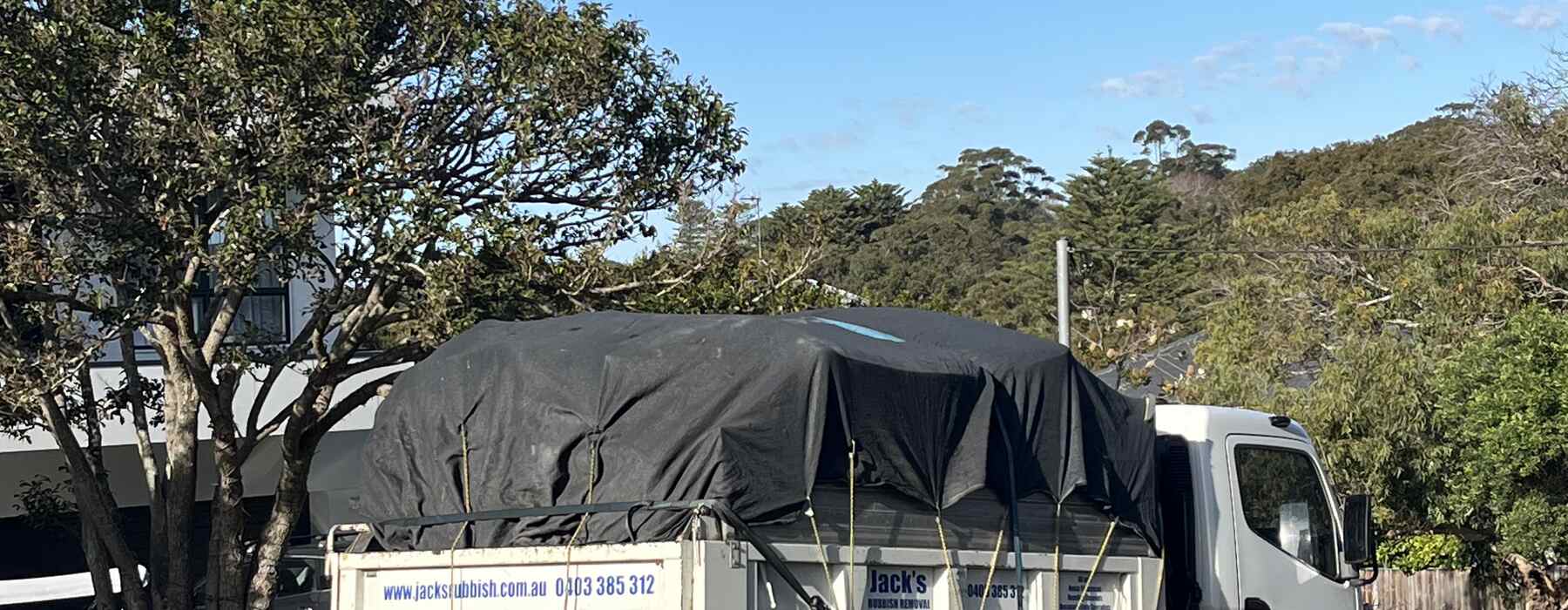 Branded tipper, bushland street